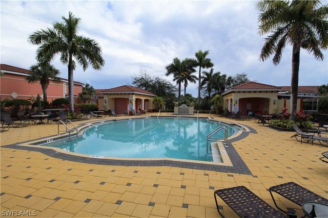a view of swimming pool with outdoor seating and plants