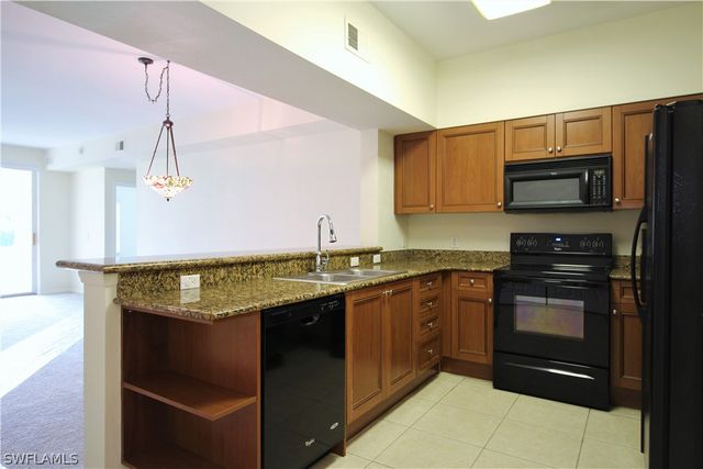 a kitchen with a sink stove and microwave