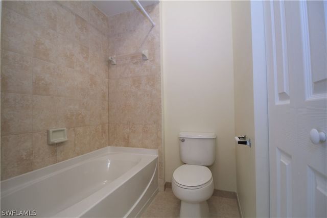 a bathroom with a toilet and a bathtub