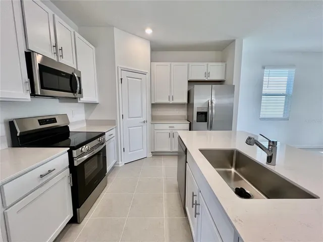 a kitchen with a sink stove and microwave