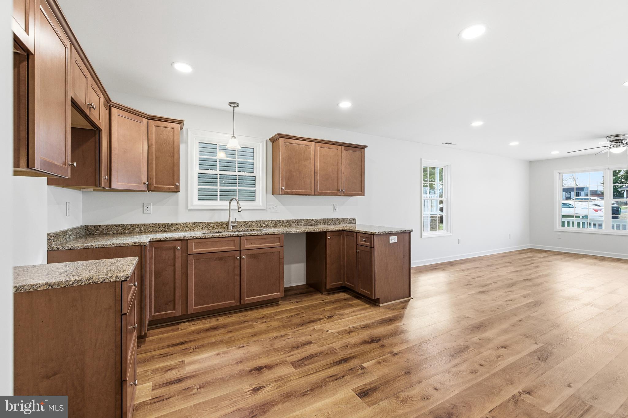103 6th Avenue Luray, VA 22835 - Photo 12 of 58 a kitchen with stainless steel appliances granite countertop a sink cabinets and wooden floor