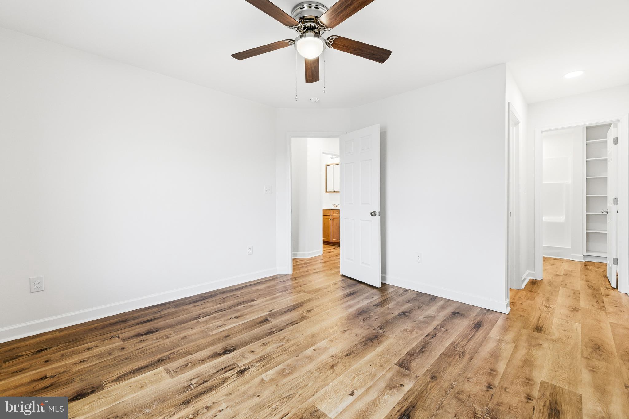 103 6th Avenue Luray, VA 22835 - Photo 20 of 58 a view of an empty room with wooden floor and a ceiling fan