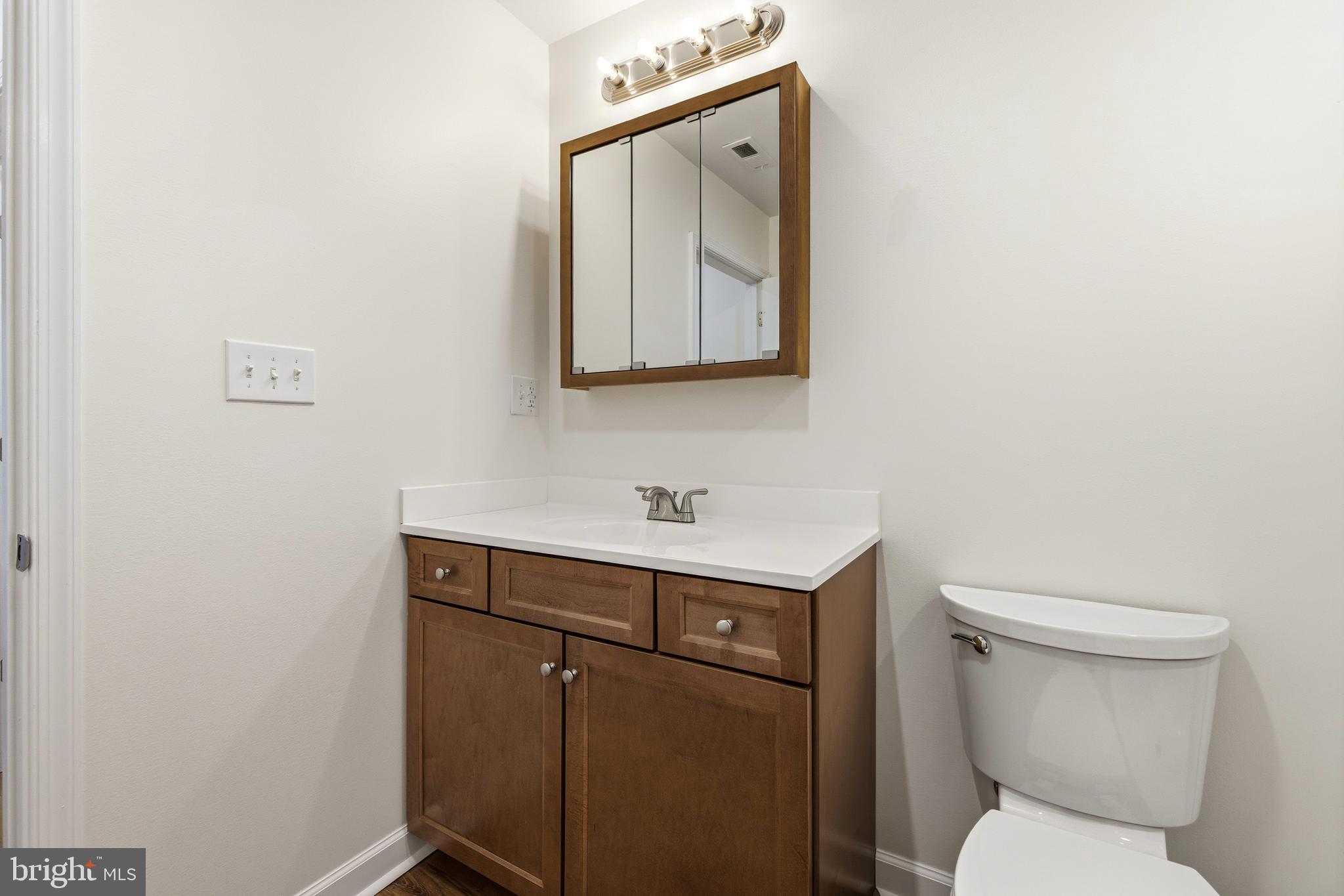 103 6th Avenue Luray, VA 22835 - Photo 23 of 58 a bathroom with a toilet a sink and mirror