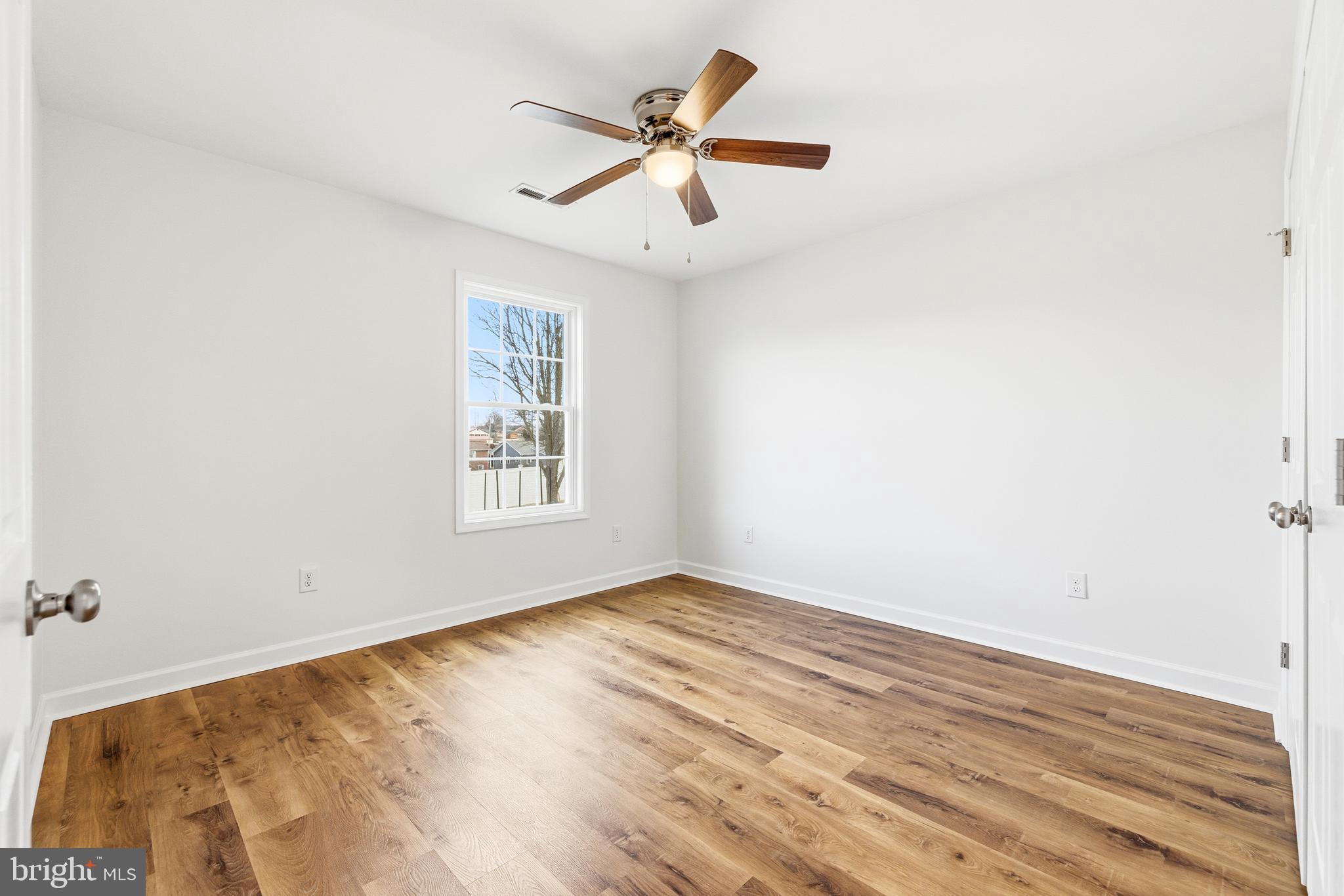 103 6th Avenue Luray, VA 22835 - Photo 24 of 58 an empty room with wooden floor and ceiling fan
