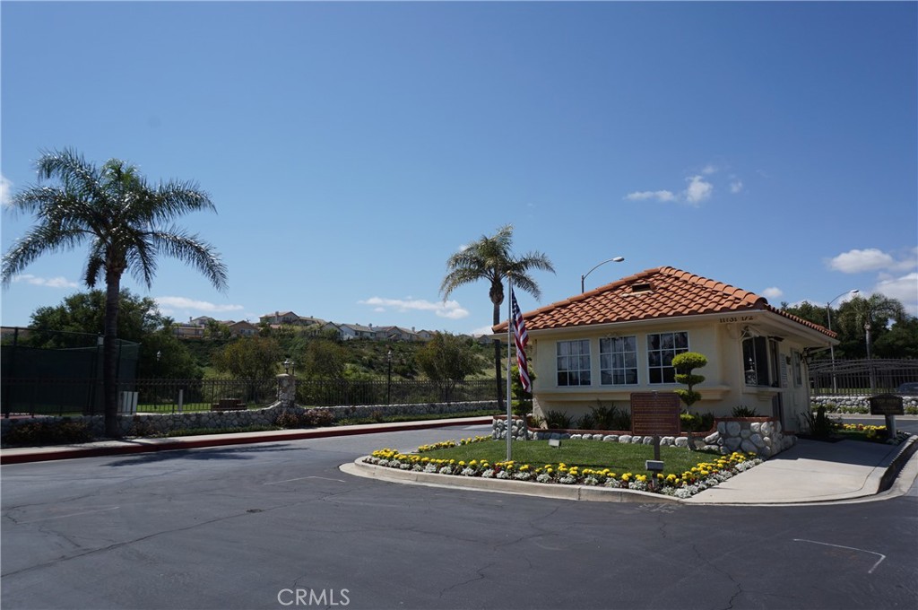 19584 Shadow Glen Circle Porter Ranch, CA 91326 - Photo 60 of 72 a front view of a house with a garden and trees