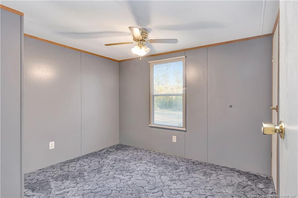 6459 Wire Grass Road Orrum, NC 28369 - Photo 14 of 22 a view of an empty room and window