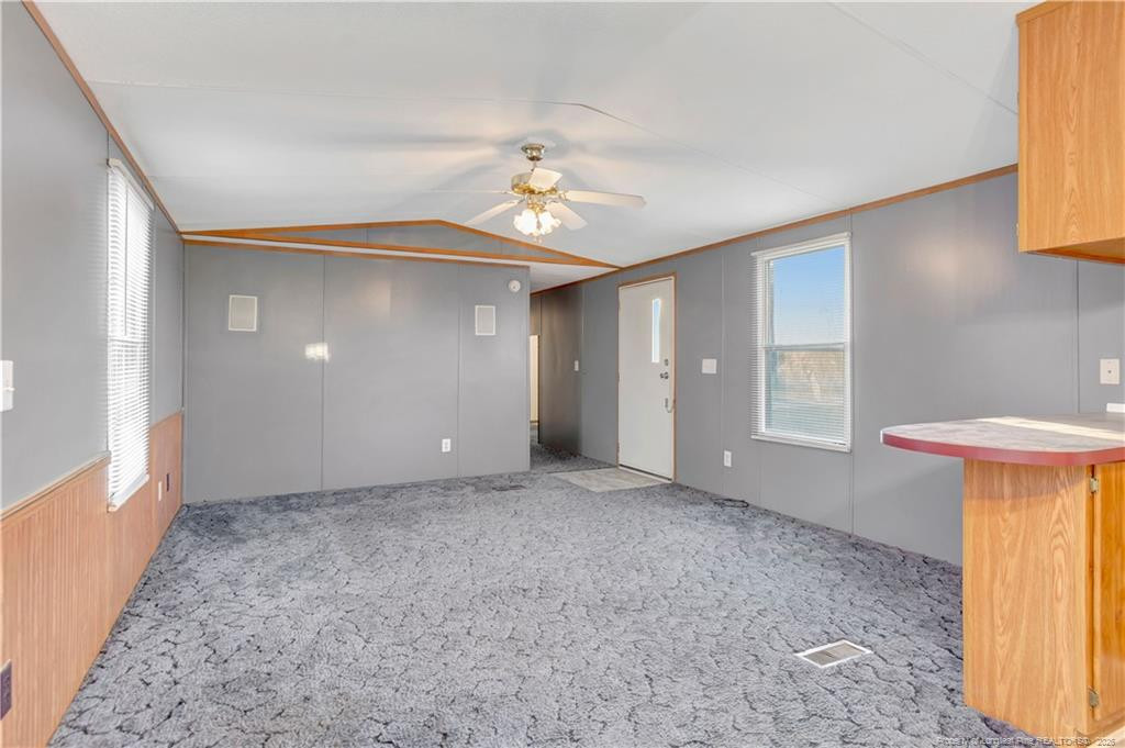 6459 Wire Grass Road Orrum, NC 28369 - Photo 5 of 22 wooden floor in an empty room with a window