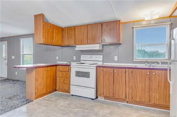 a view of a kitchen with a refrigerator and a sink