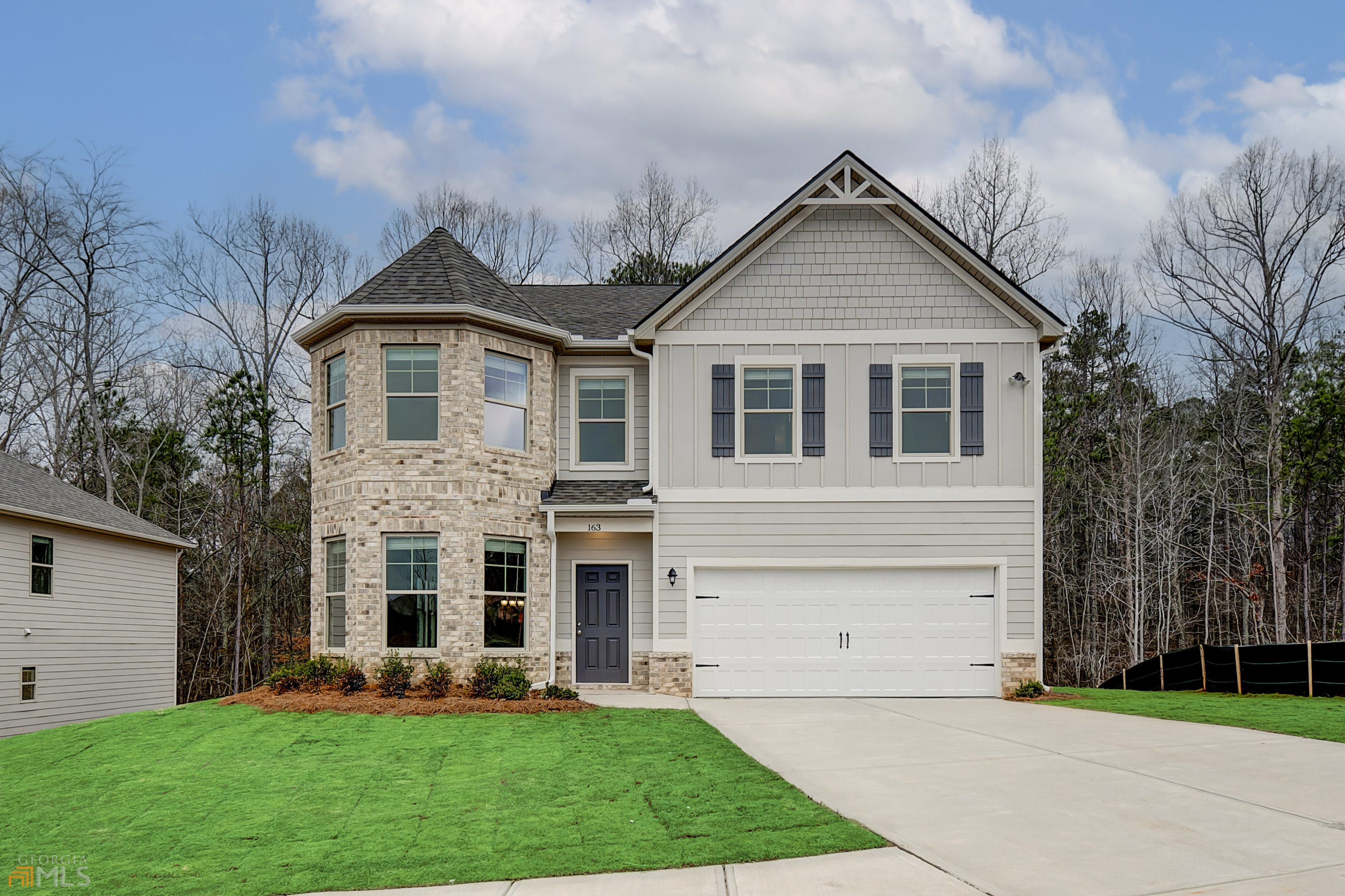 a front view of house with yard and green space