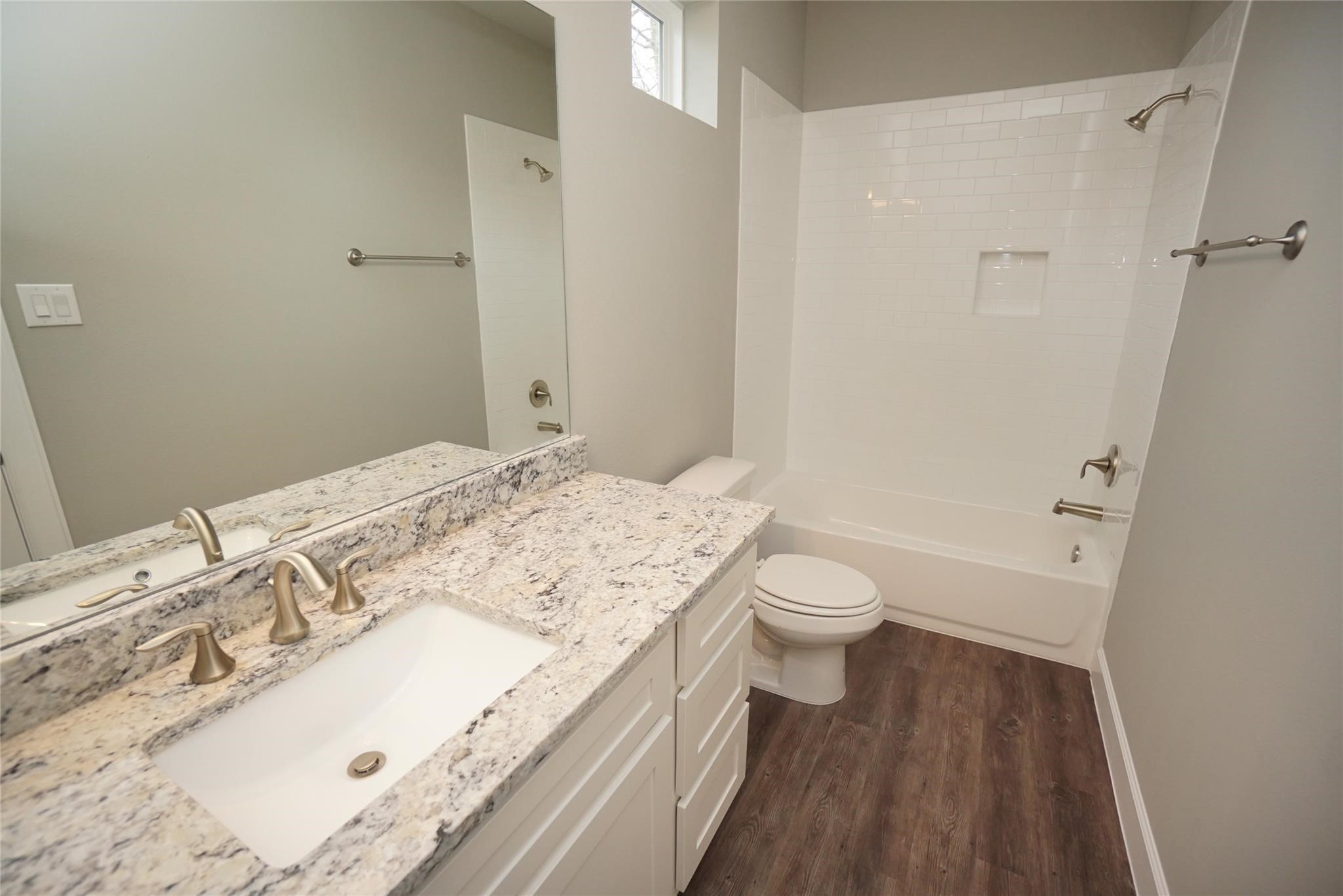 1137 4th Street Rosenberg, TX 77471 - Photo 9 of 16 a bathroom with a granite countertop sink a toilet and shower