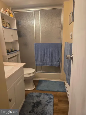 a bathroom with a toilet and a shower