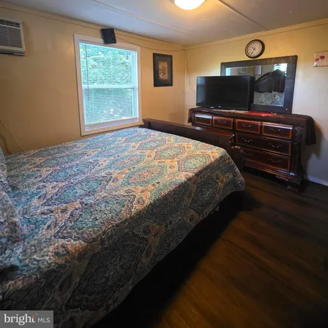 a bedroom with a bed and a television