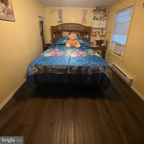 a bed sitting in a bedroom next to a window