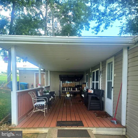 a view of a patio with table and chairs