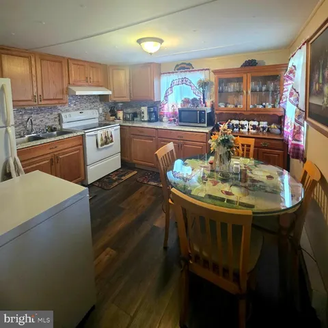 a kitchen with a table chairs stove and cabinets