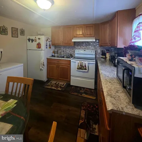 a kitchen with a stove and a refrigerator