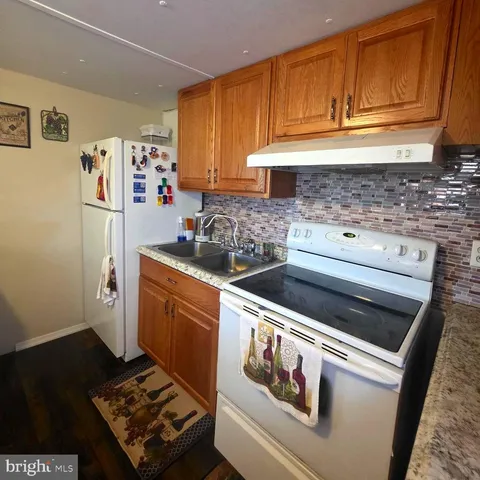 a kitchen with stainless steel appliances granite countertop a stove and a refrigerator