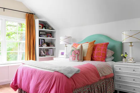 a bedroom with a bed and a book shelf
