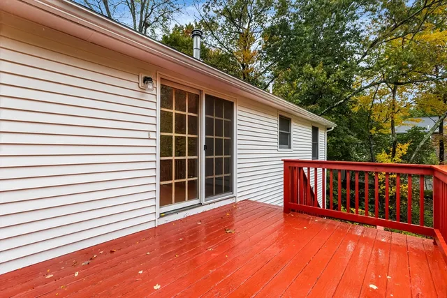 a balcony with wooden floor and fence
