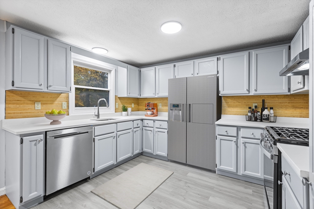 7 Westwood Road Natick, MA 01760 - Photo 2 of 11 a kitchen with stainless steel appliances granite countertop a refrigerator sink and stove