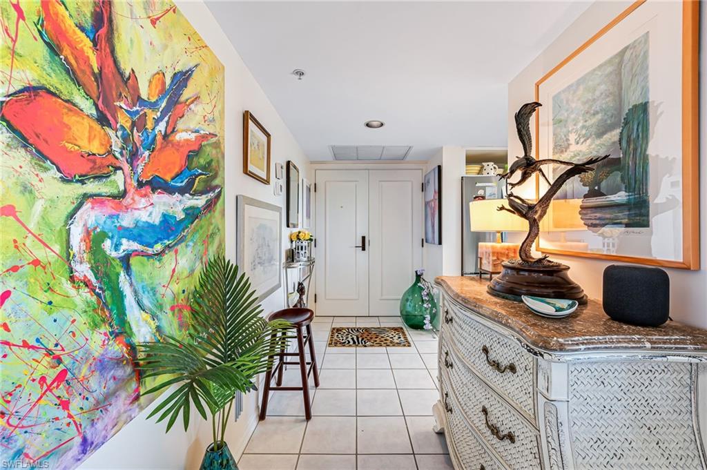 a kitchen with stainless steel appliances a sink a table and a painting on the wall
