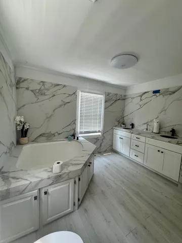 a bathroom with a sink a mirror and shower