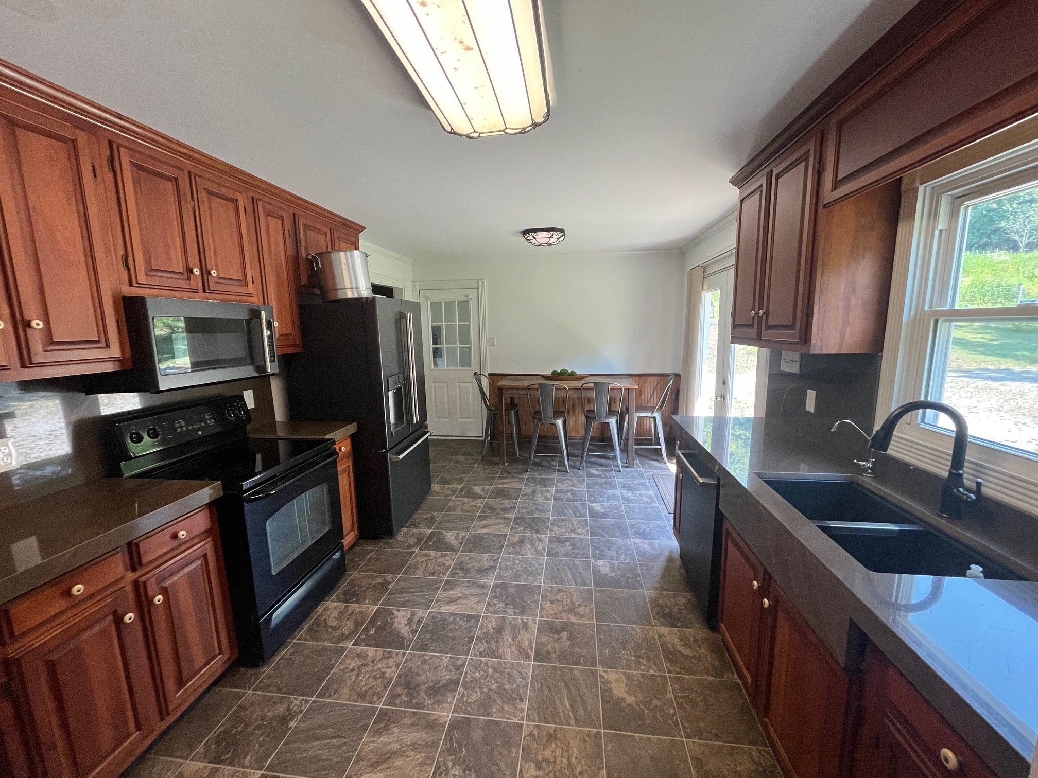 1450 Donna Road Lewisburg, TN 37091 - Photo 6 of 33 a kitchen with kitchen island granite countertop a sink counter top space appliances and cabinets