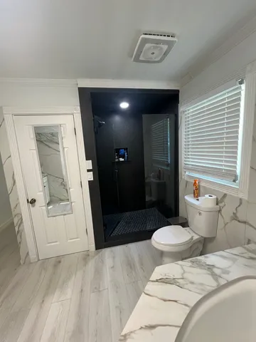 a bedroom with a bed and a mirror