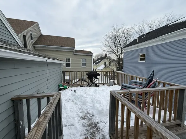 a view of a roof deck with wooden fence and floor