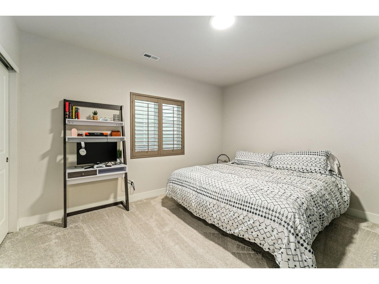 5018 Leopold Loop Timnath, CO 80547 - Photo 38 of 50 a bedroom with a bed and a tv