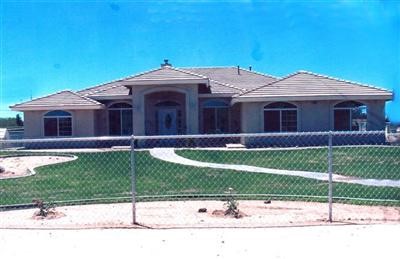 1620 Smoke Tree Road Pinon Hills, CA 92372 - Photo 1 of 1 a front view of a house with a yard and a garage