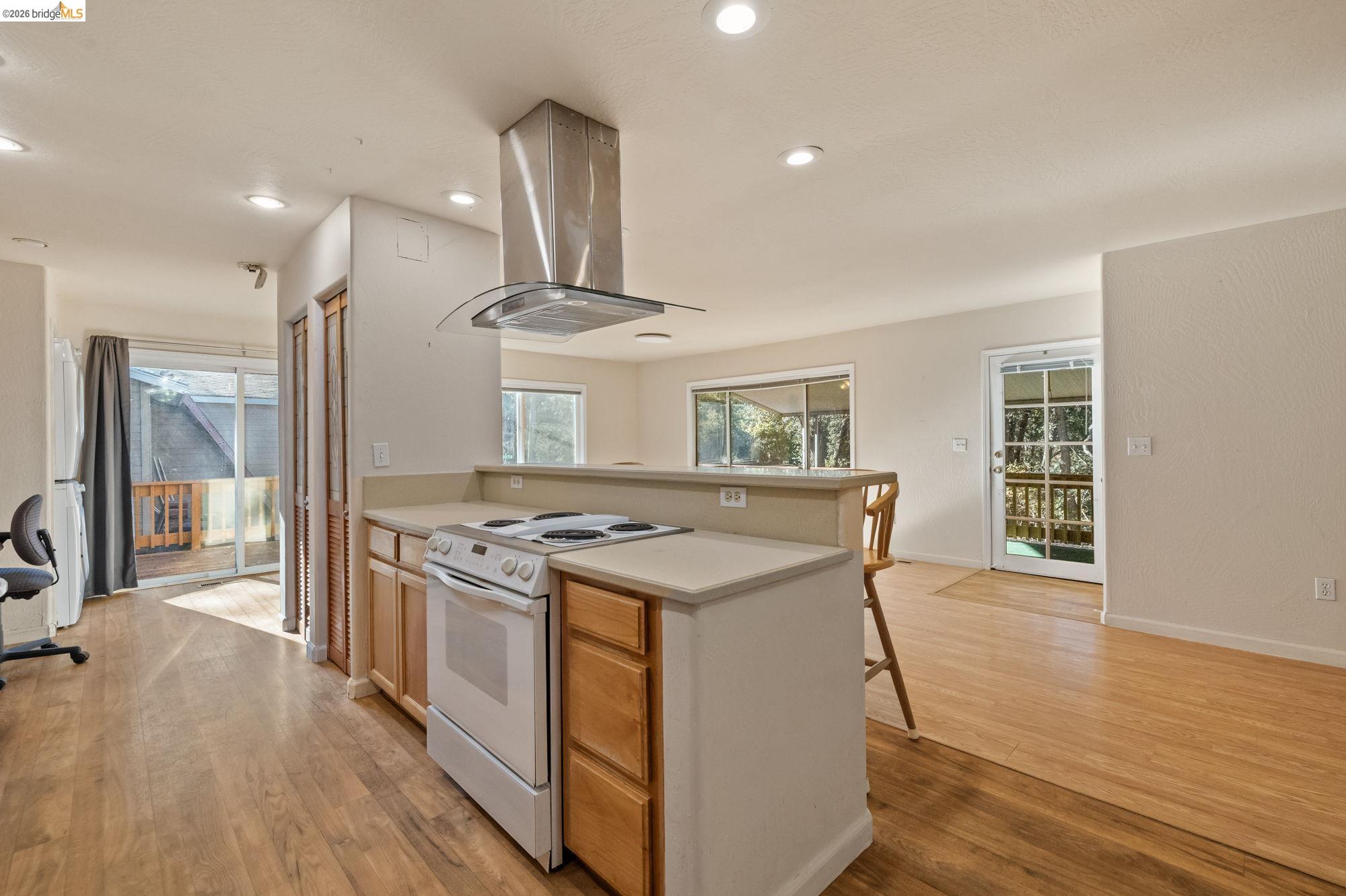 13904 Tuolumne Road Sonora, CA 95370 - Photo 13 of 31 a kitchen with a stove and wooden floor