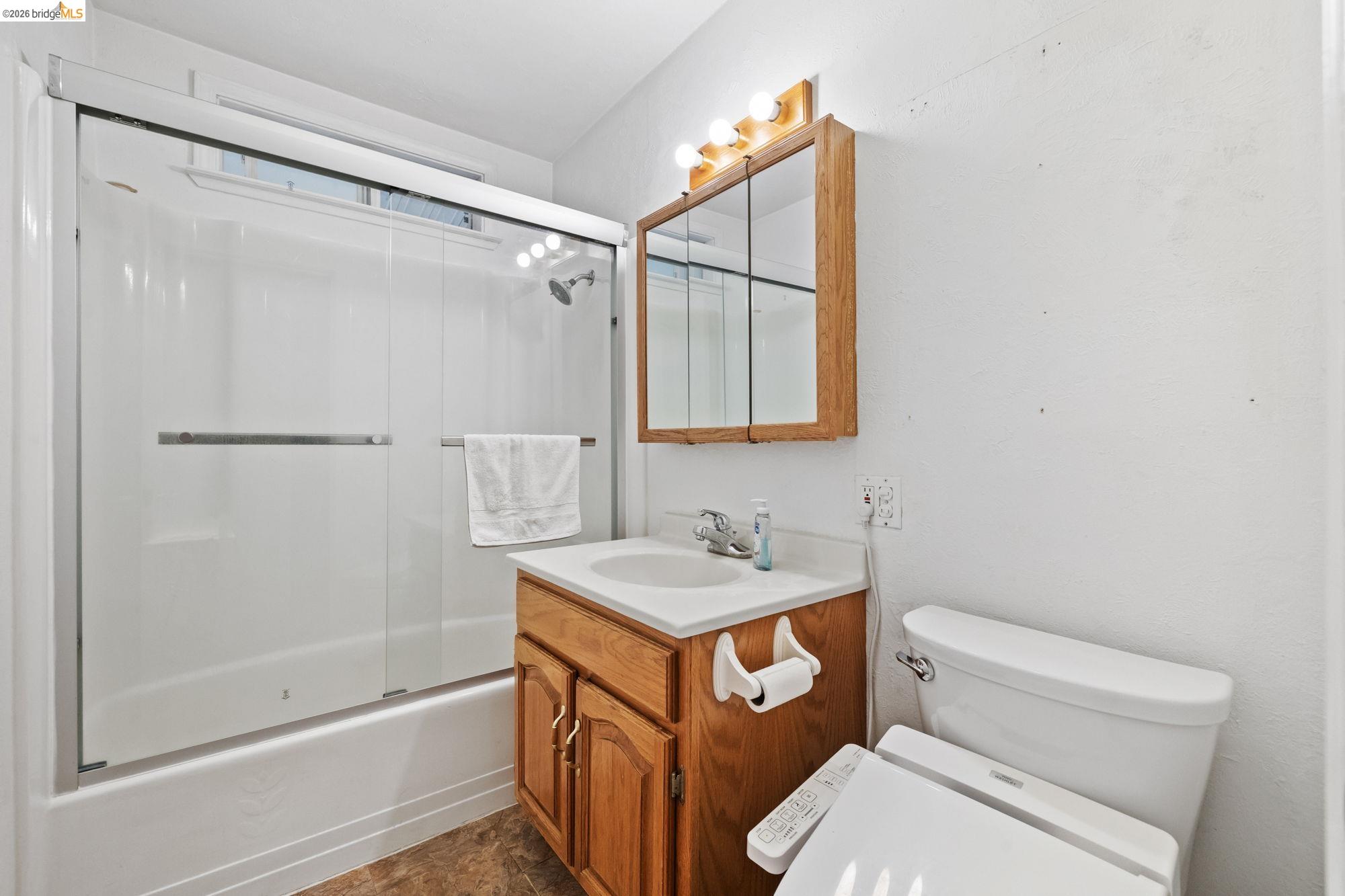 13904 Tuolumne Road Sonora, CA 95370 - Photo 17 of 31 a bathroom with a granite countertop sink mirror vanity and toilet