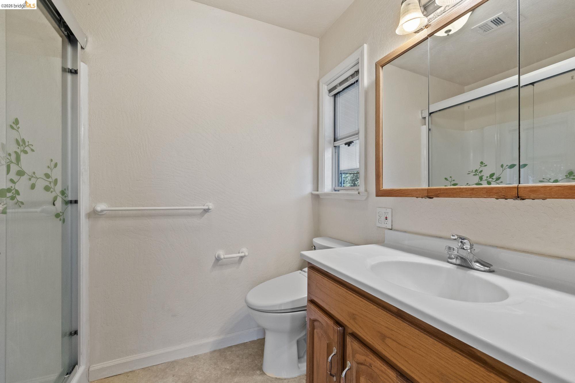 13904 Tuolumne Road Sonora, CA 95370 - Photo 23 of 31 a bathroom with a granite countertop sink toilet and mirror