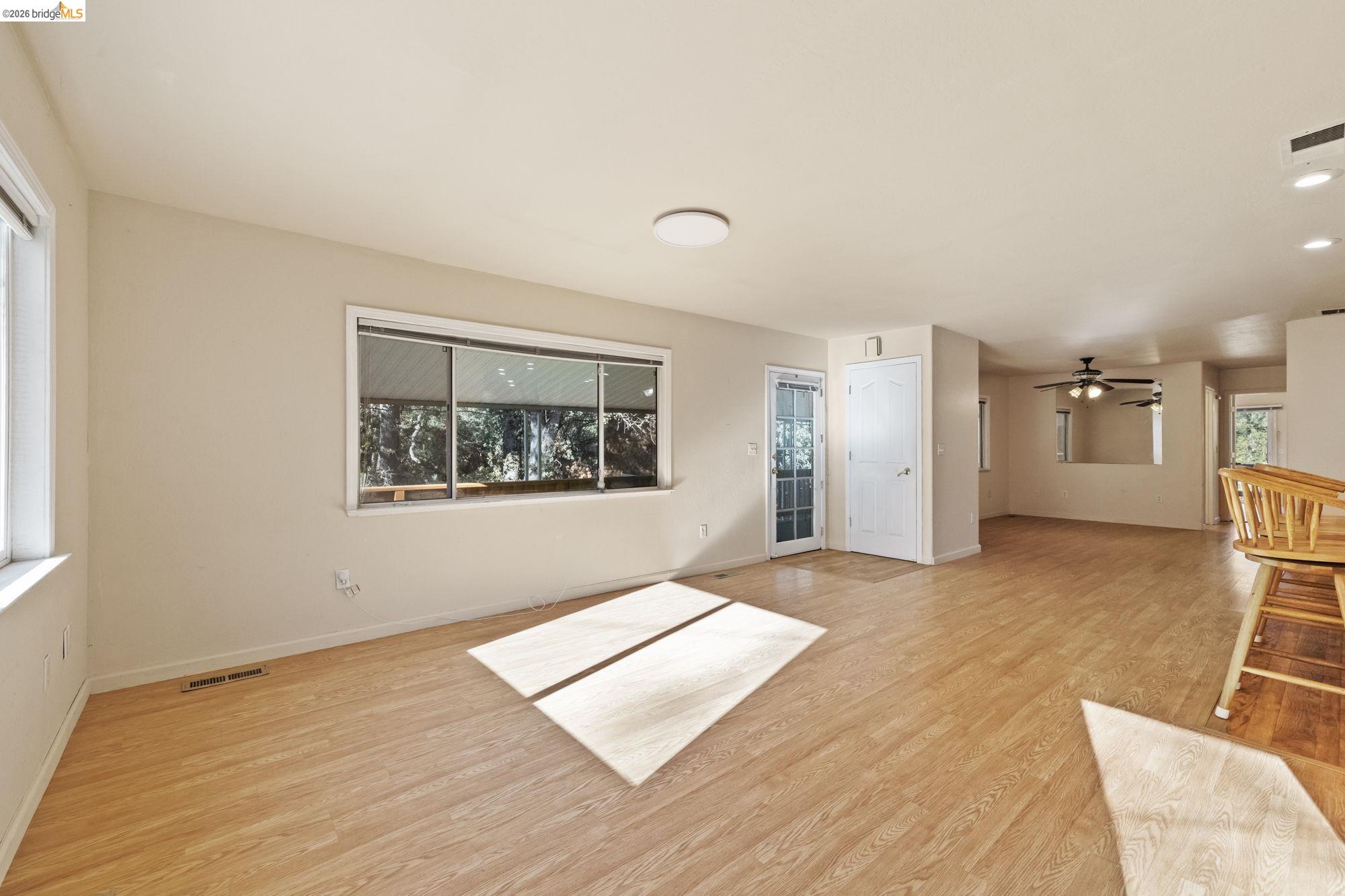 13904 Tuolumne Road Sonora, CA 95370 - Photo 4 of 31 a view of an empty room with wooden floor and a window