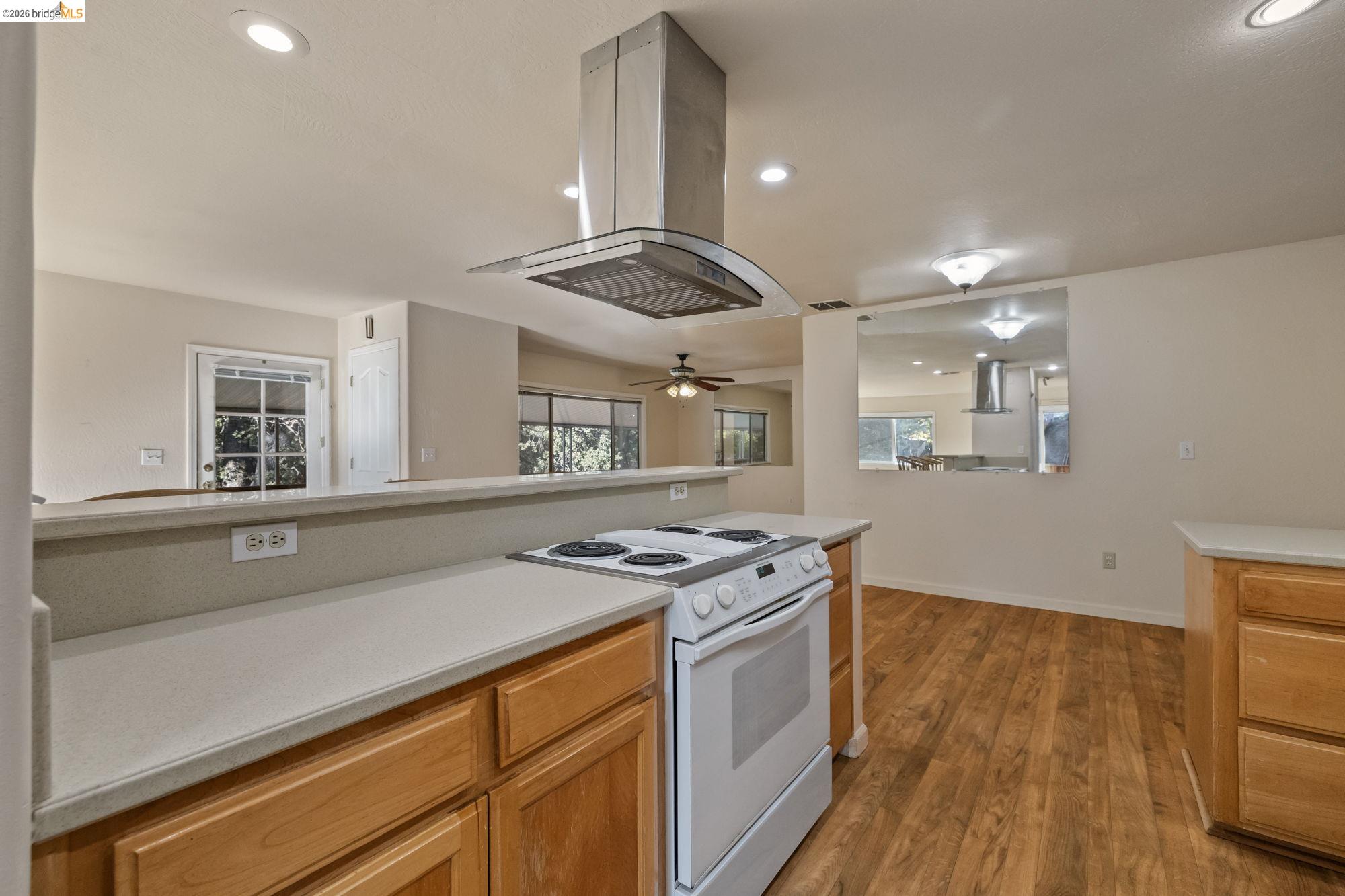 13904 Tuolumne Road Sonora, CA 95370 - Photo 10 of 31 a kitchen with stainless steel appliances granite countertop a stove and a wooden floors