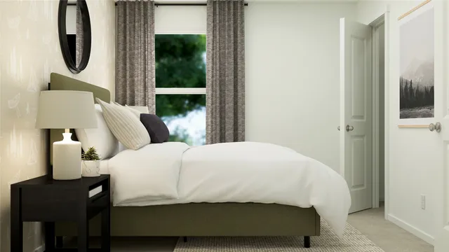 a bedroom with a bed a mirror and lamp next to a window