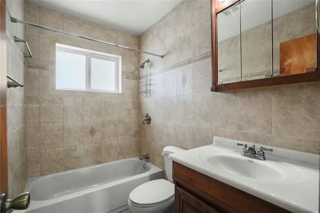 a bathroom with a sink toilet a mirror and shower