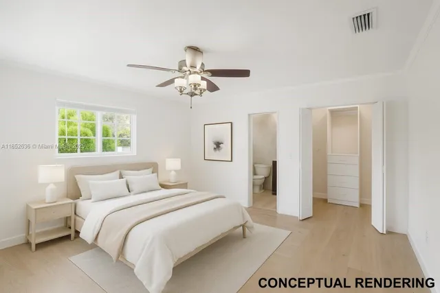 a bedroom with a large bed and a chandelier