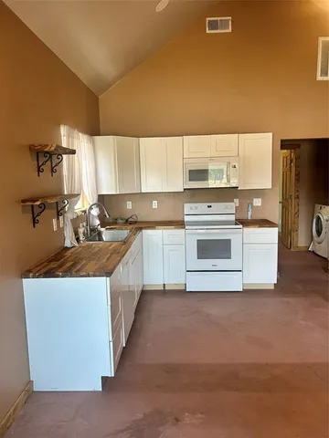 a kitchen with stainless steel appliances a stove top oven