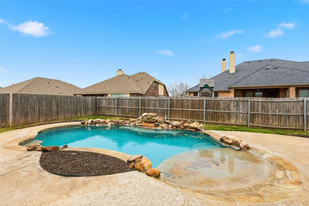 5038 West Fall Drive Midlothian, TX 76065 - Photo 1 of 40 Splash into your new pool! View of pool featuring a fenced backyard and patio surround
