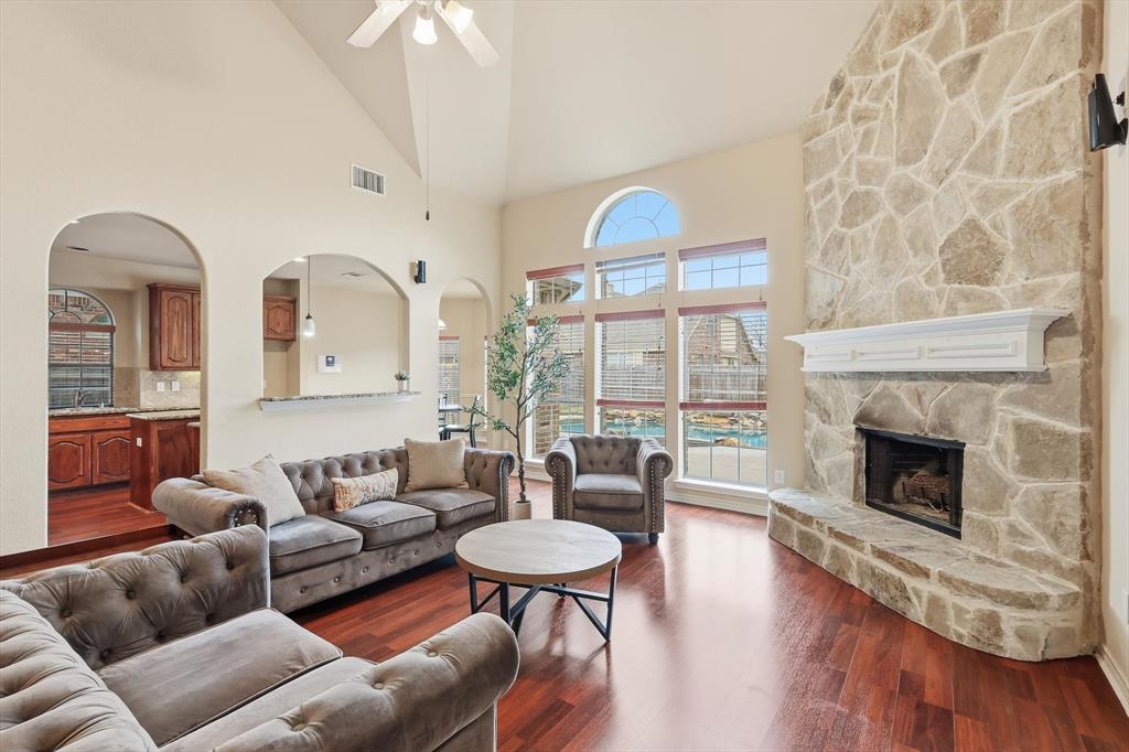 5038 West Fall Drive Midlothian, TX 76065 - Photo 2 of 40 Enjoy quality time in an open living area with wood burning stone fireplace and view of the pool.