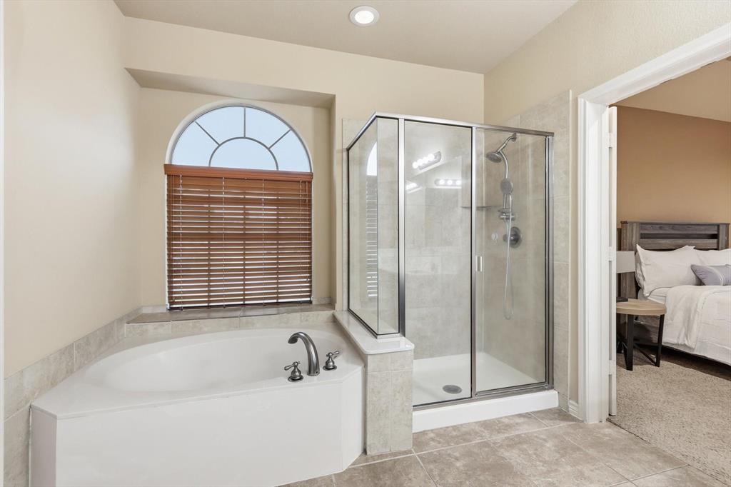 5038 West Fall Drive Midlothian, TX 76065 - Photo 22 of 40 Ensuite bathroom with a bath, a stall shower, and light carpet