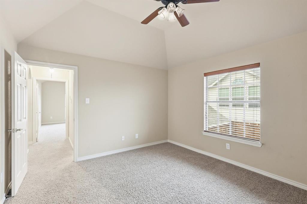 5038 West Fall Drive Midlothian, TX 76065 - Photo 29 of 40 Empty room featuring light colored carpet, lofted ceiling, and ceiling fan
