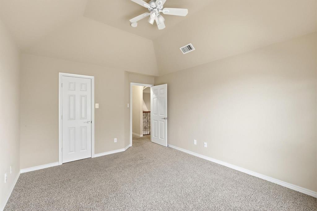 5038 West Fall Drive Midlothian, TX 76065 - Photo 32 of 40 Unfurnished bedroom with carpet floors, lofted ceiling, and a ceiling fan