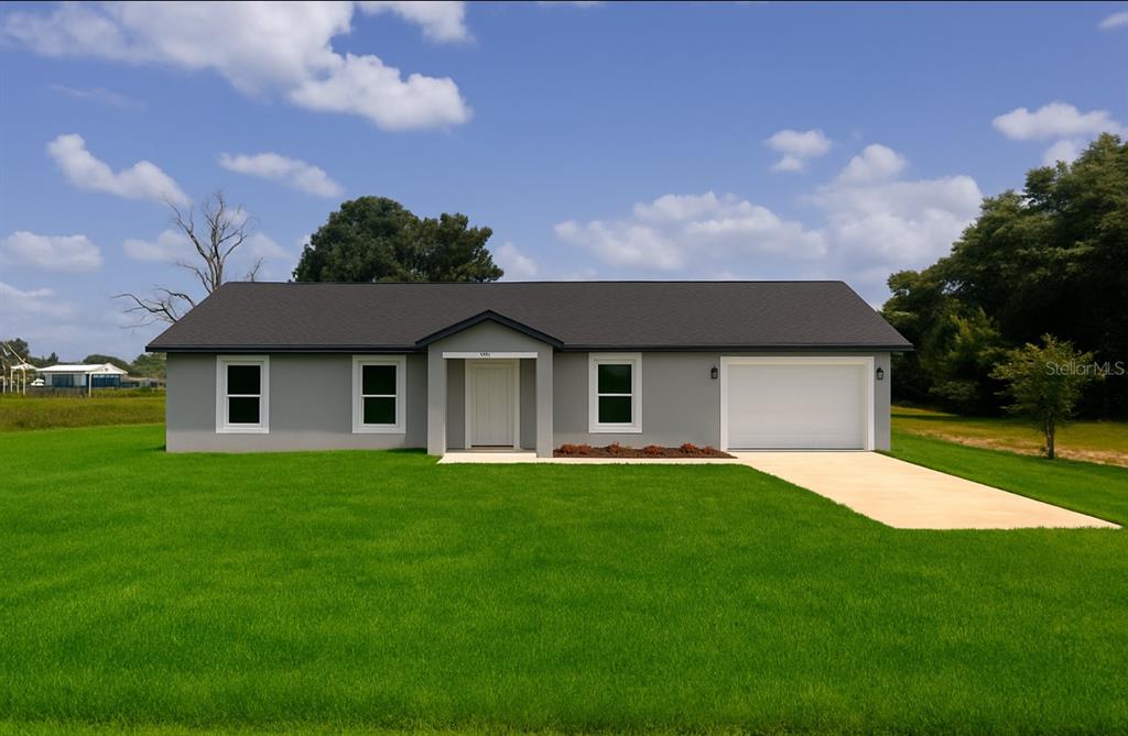 14945 Southwest 34 Street Ocala, FL 34481 - Photo 1 of 1 a front view of a house with a yard and garage