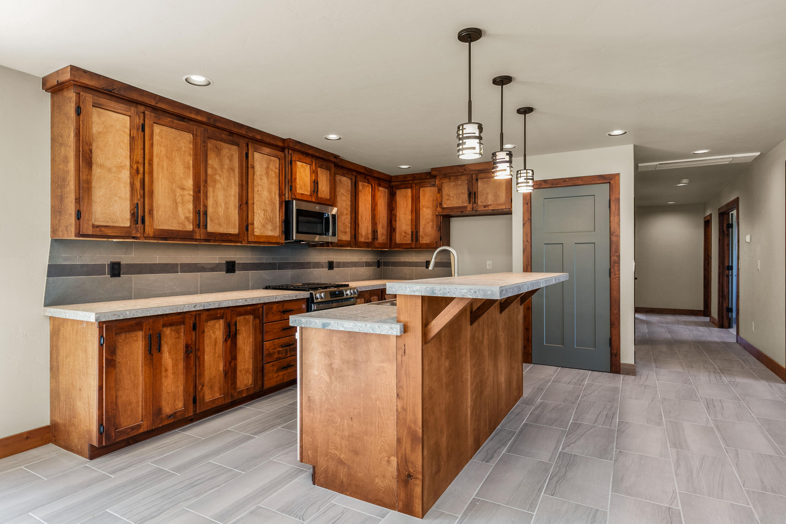 1472 Northeast Hudspeth Road Prineville, OR 97754 - Photo 12 of 26 a kitchen with stainless steel appliances granite countertop a stove a sink dishwasher a refrigerator and a microwave