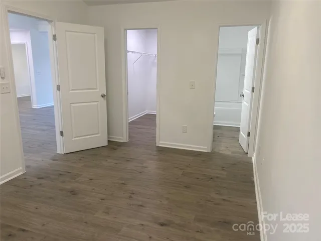 an empty room with an entrance to other room