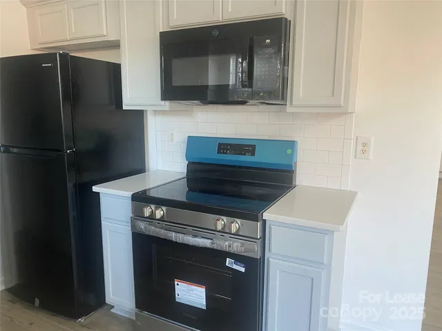 a kitchen with a stove and a microwave