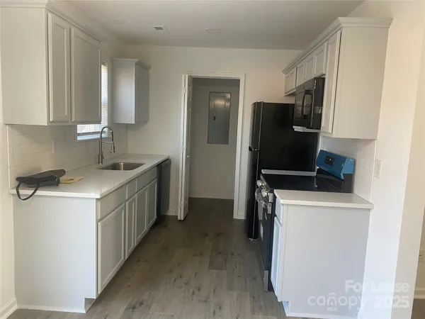a kitchen with a sink stove and refrigerator
